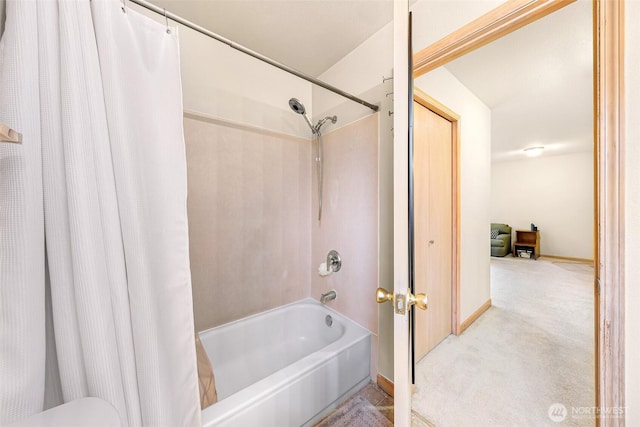 full bathroom featuring shower / bath combo and baseboards