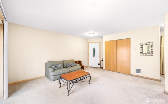 living room with baseboards, visible vents, and light colored carpet