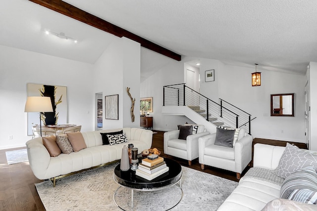 living area with vaulted ceiling with beams, dark wood-type flooring, a textured ceiling, baseboards, and stairs