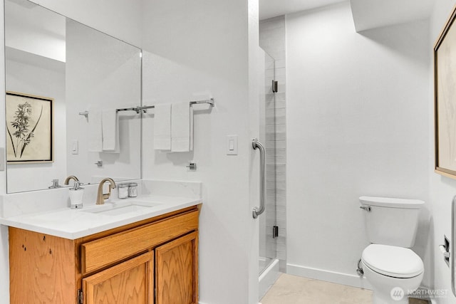 full bathroom featuring toilet, vanity, baseboards, a shower stall, and tile patterned floors