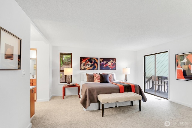 bedroom with access to outside, a textured ceiling, and light colored carpet