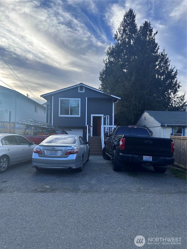 view of front of home featuring fence