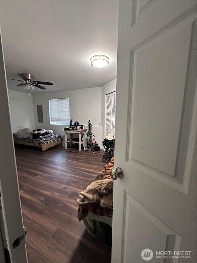 interior space featuring electric panel and wood finished floors