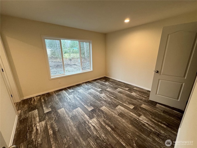 unfurnished bedroom with dark wood-type flooring, recessed lighting, and baseboards