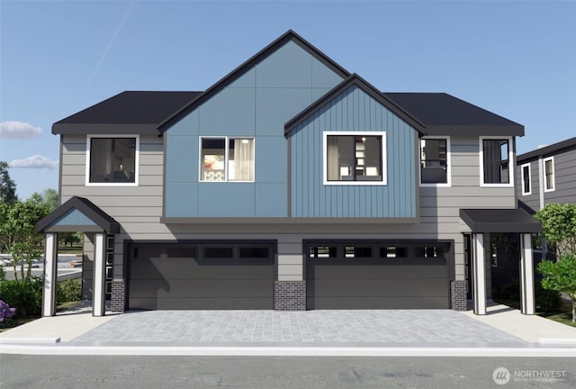 view of front of property with a garage, brick siding, and board and batten siding