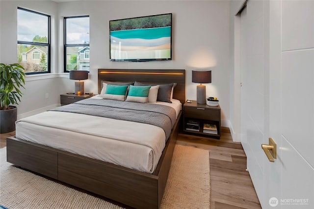 bedroom featuring baseboards and wood finished floors