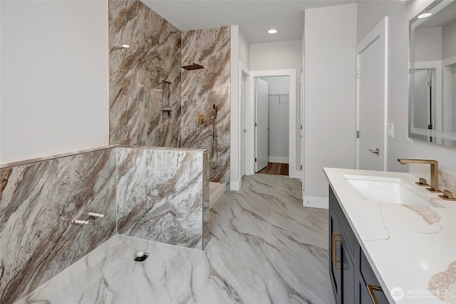 bathroom with vanity, marble finish floor, and walk in shower