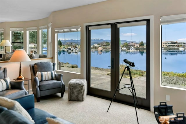 sunroom / solarium with a water view