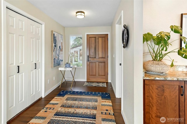 entrance foyer with baseboards and dark wood-style floors