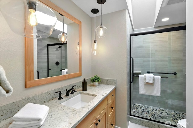 bathroom with vanity and a stall shower