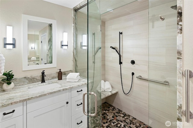 full bath featuring vanity and a shower stall