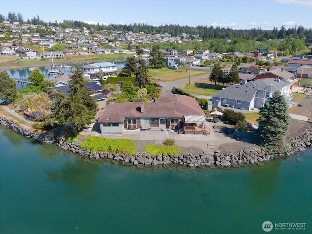 drone / aerial view featuring a residential view and a water view