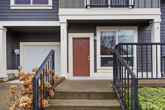 doorway to property with a garage and board and batten siding