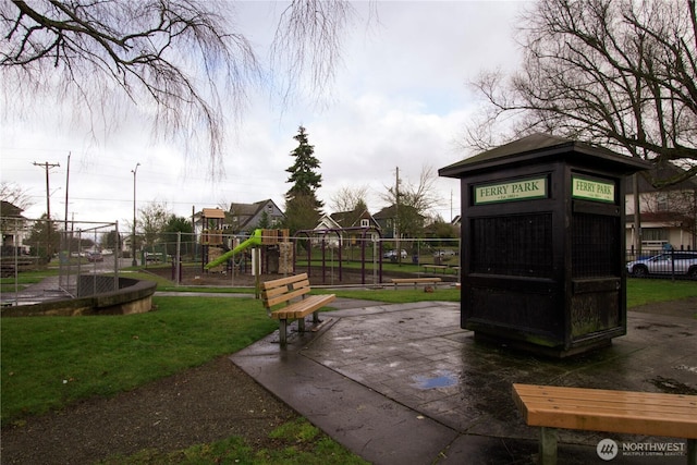 communal playground featuring fence and a lawn