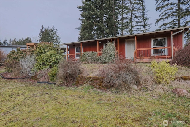 single story home with a front lawn and board and batten siding