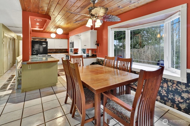 dining space with wood ceiling, ceiling fan, and light tile patterned flooring