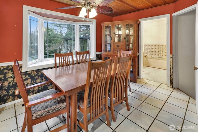 dining space with light tile patterned floors, ceiling fan, and wooden ceiling