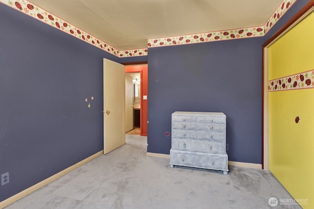 unfurnished bedroom featuring carpet floors and baseboards