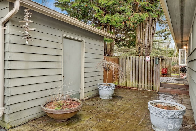 view of outbuilding featuring fence