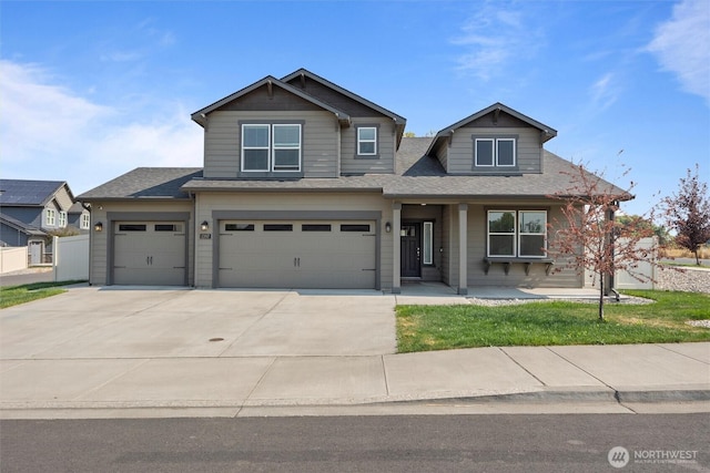 craftsman house featuring an attached garage, a shingled roof, a porch, and concrete driveway