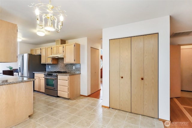 kitchen featuring decorative light fixtures, stainless steel appliances, light brown cabinets, a chandelier, and under cabinet range hood