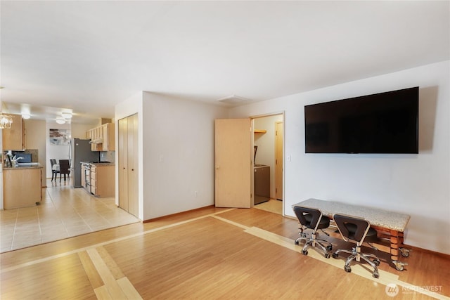 living room featuring an inviting chandelier and light wood-style floors