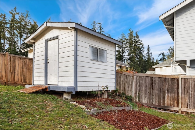 view of shed featuring fence