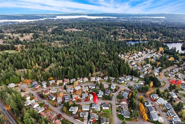 aerial view with a residential view, a water view, and a forest view