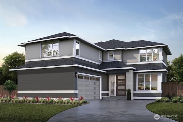 prairie-style home featuring a garage, concrete driveway, fence, and a shingled roof