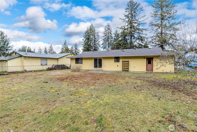 back of house featuring a lawn and a patio area