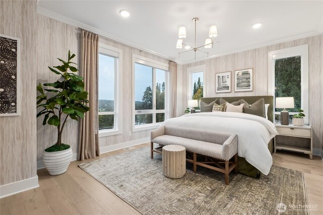 bedroom with a chandelier, baseboards, wood finished floors, and crown molding