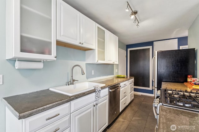 kitchen featuring glass insert cabinets, stainless steel appliances, white cabinets, and a sink