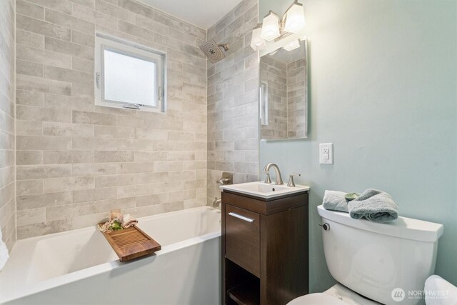 full bathroom featuring toilet, bathing tub / shower combination, and vanity