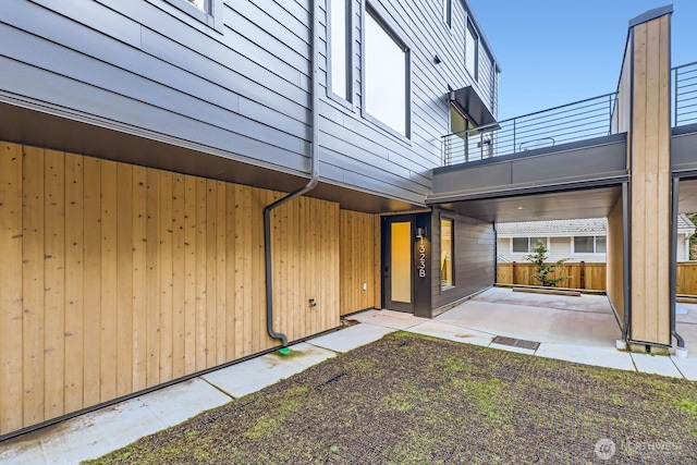 back of house with a balcony and a patio area