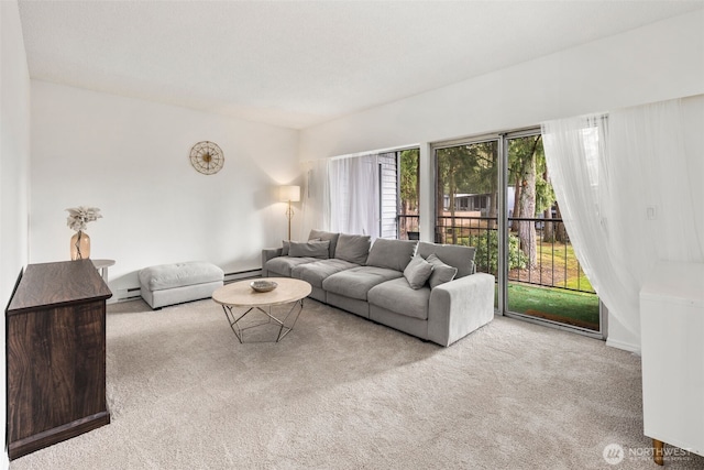 living area featuring a baseboard heating unit and light carpet