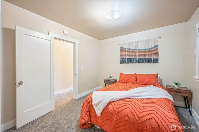 carpeted bedroom with visible vents and baseboards