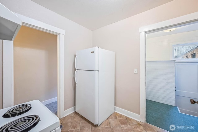 kitchen with white appliances and baseboards