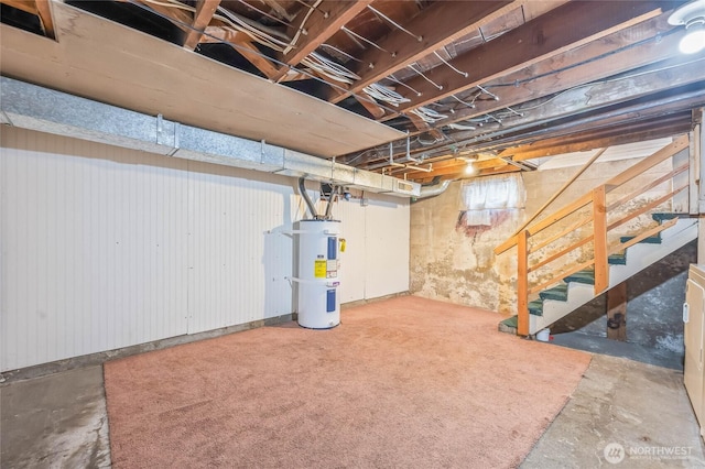 unfinished basement with water heater and stairway