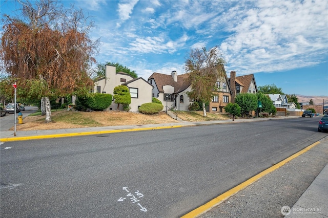 view of road with curbs, sidewalks, and a residential view