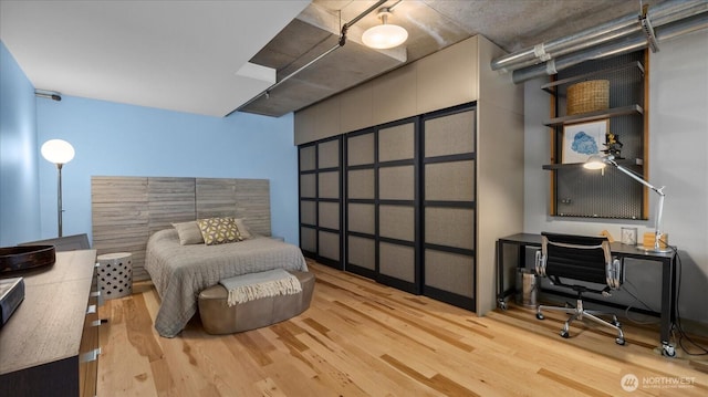 bedroom with wood finished floors