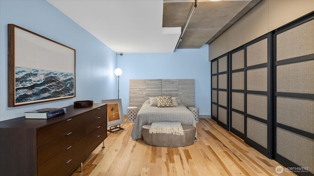 bedroom with baseboards and wood finished floors