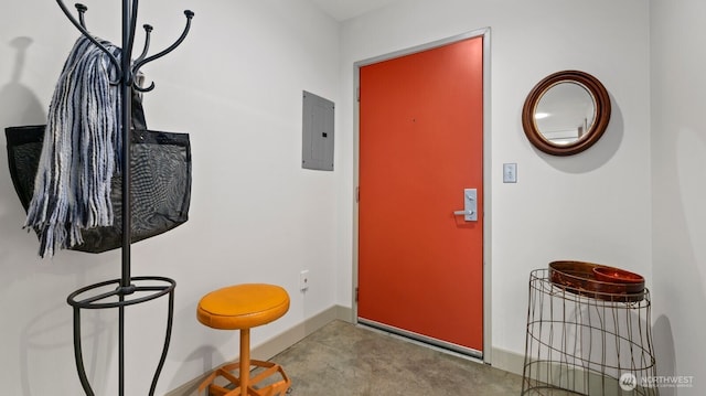 entryway with electric panel, baseboards, and concrete flooring