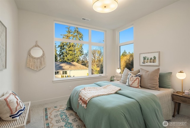 carpeted bedroom with baseboards and visible vents