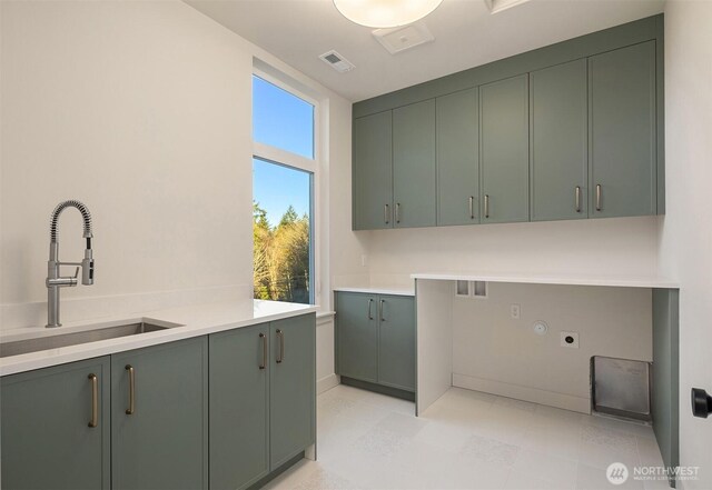 washroom with cabinet space, visible vents, a sink, and hookup for an electric dryer