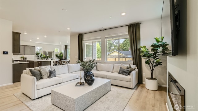 living room featuring light wood-style floors, a wealth of natural light, and recessed lighting