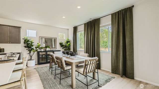 dining room featuring baseboards, recessed lighting, and light wood-style floors