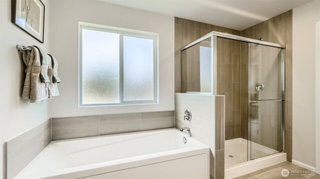 bathroom with a stall shower and a bath