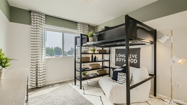 bedroom featuring light carpet, visible vents, and baseboards