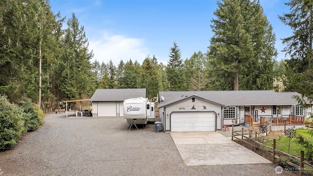 view of front facade with a porch, driveway, and a garage