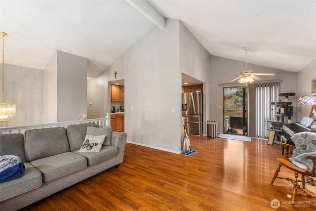 living room featuring high vaulted ceiling, ceiling fan with notable chandelier, baseboards, beam ceiling, and light wood finished floors